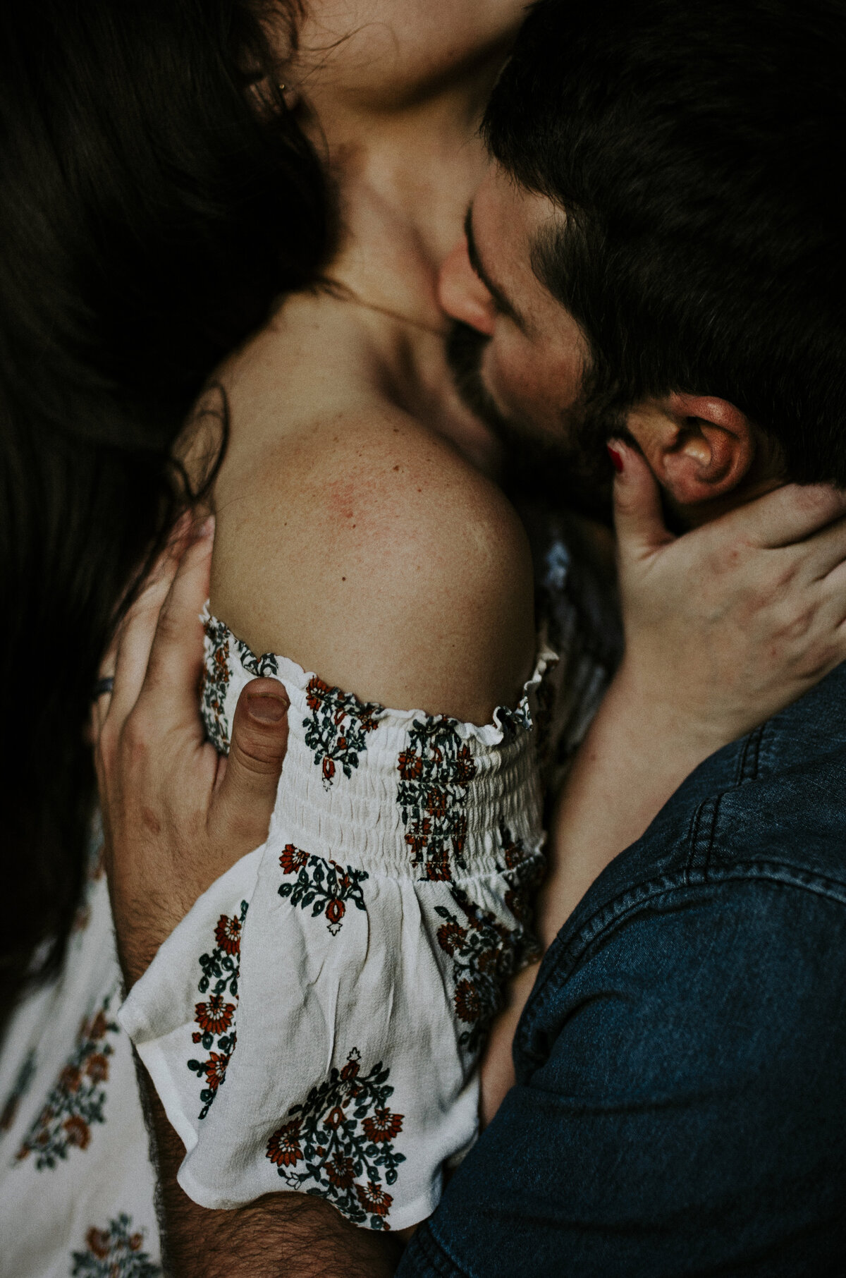Capturing the essence of love, this intimate portrait showcases a tender moment as a husband passionately kisses his wife's neck. Explore the beauty of connection and romance in this evocative couple's portra