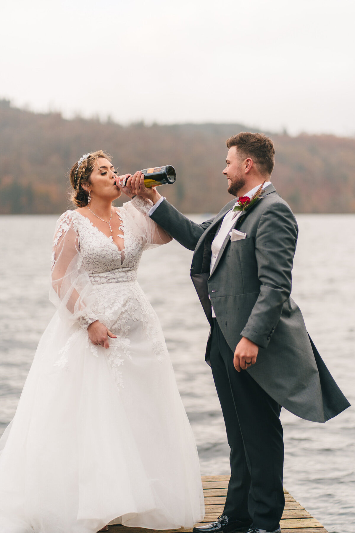 bride and groom drinking champagne at Miller Ground on lake windermere inthe lake district taken  by wedding photographer Anthony Horseman