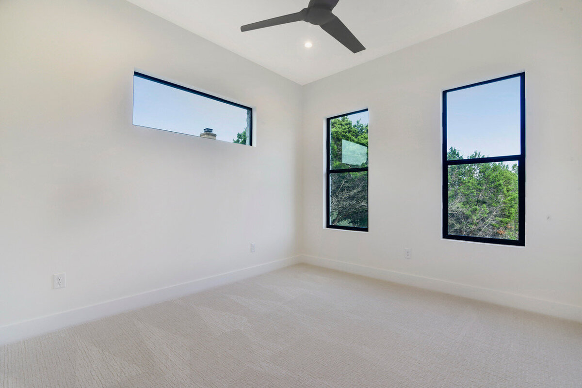 horizontal and vertical black windows in carpeted bedroom