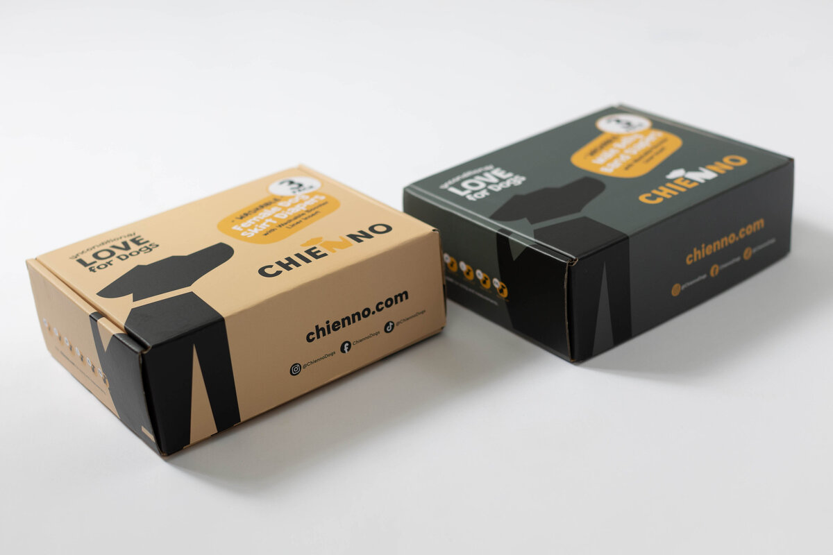Two branded cardboard boxes with a dog logo