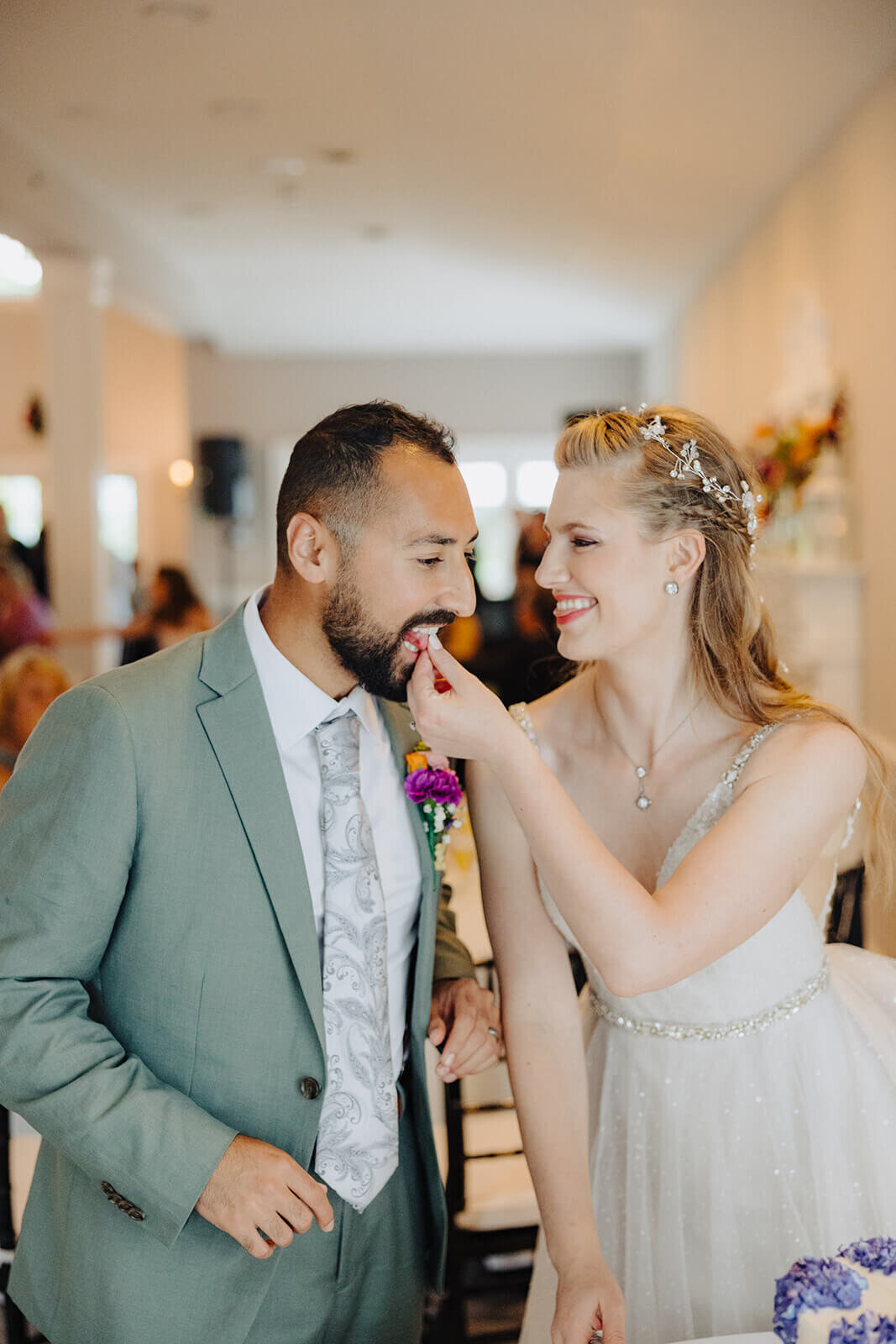 Bride feeding groom at Keuka Lake wedding, NY
