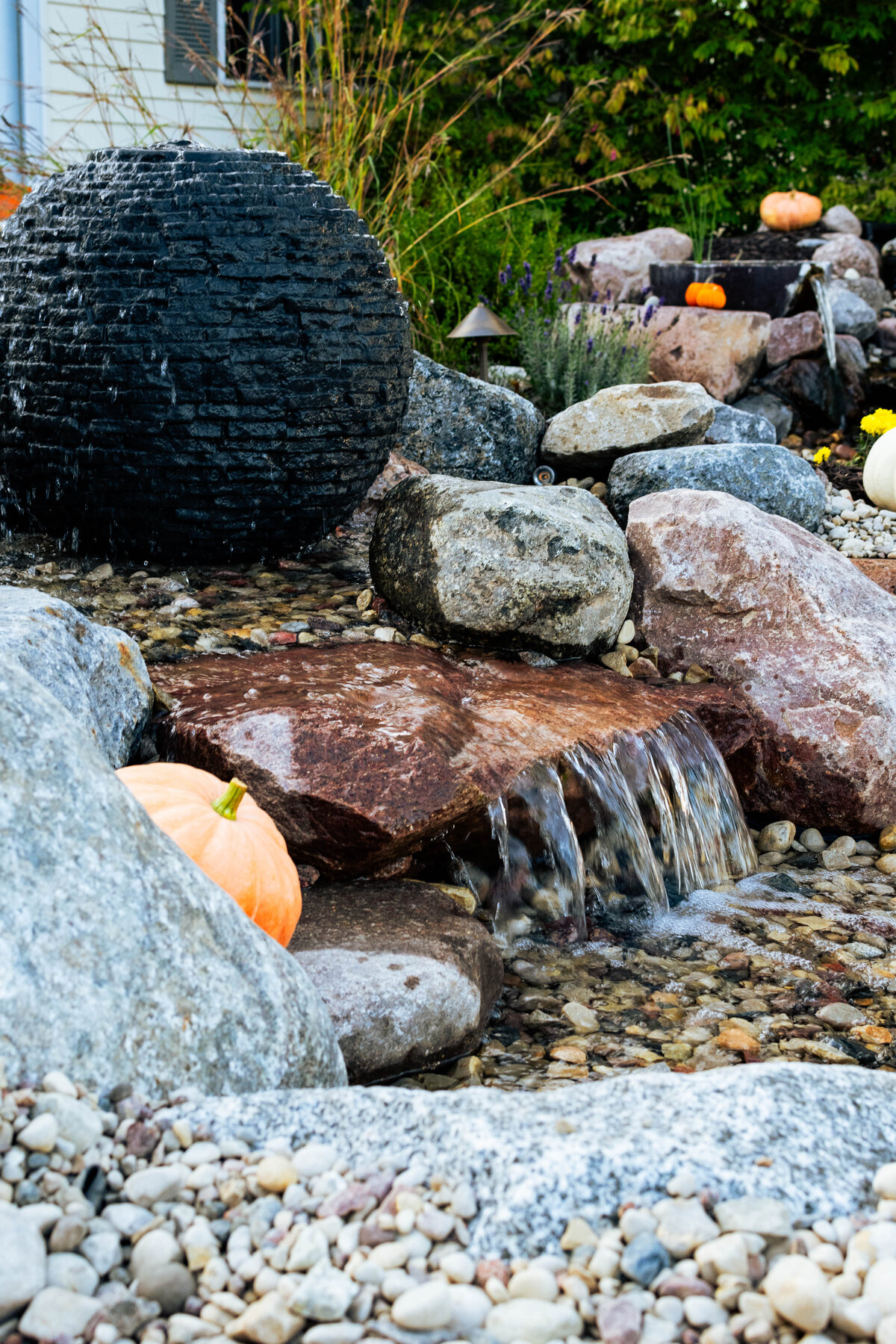 Stacked Slate Sphere fountain running into waterfall