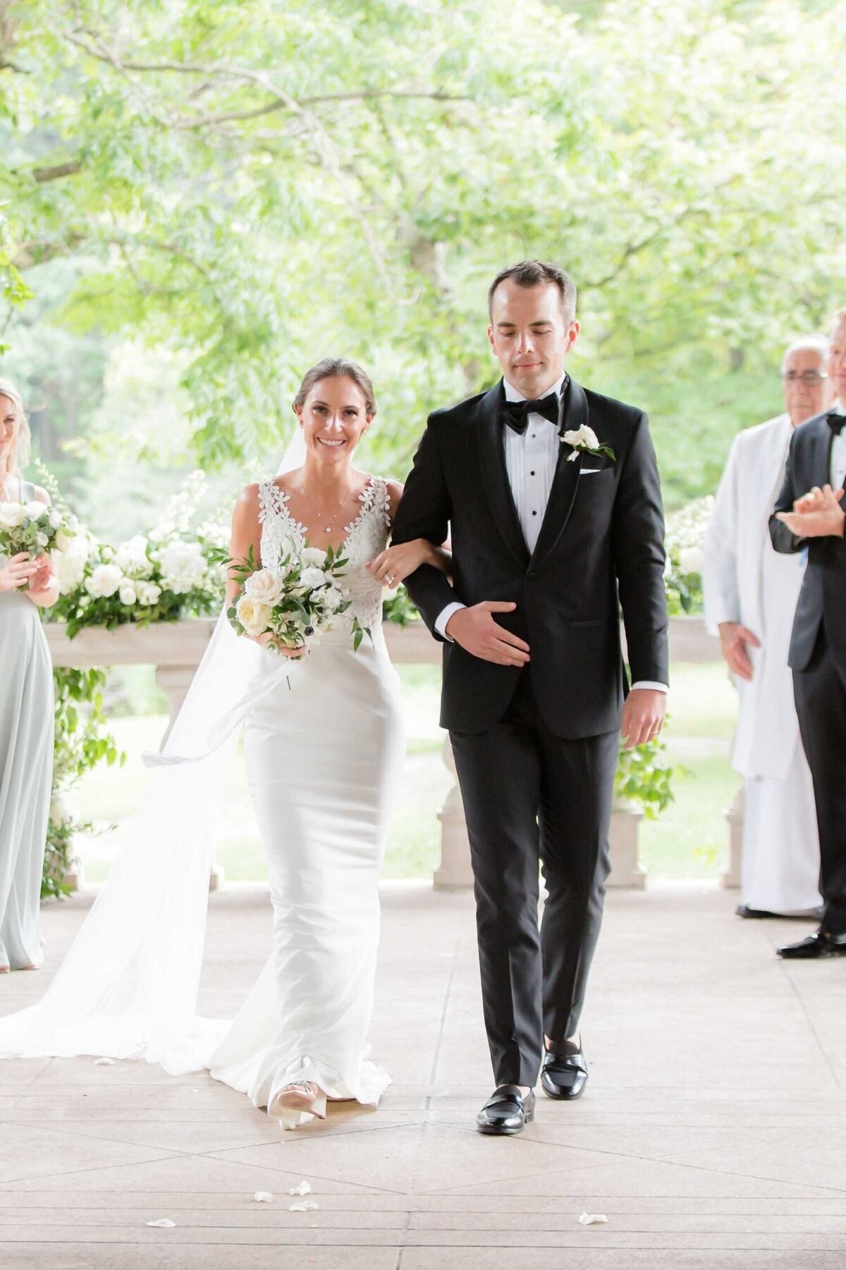 Bride and Groom walking down the aisle at Columbus Park Refectory for a Luxury Chicago Outdoor Historic Wedding Venue.