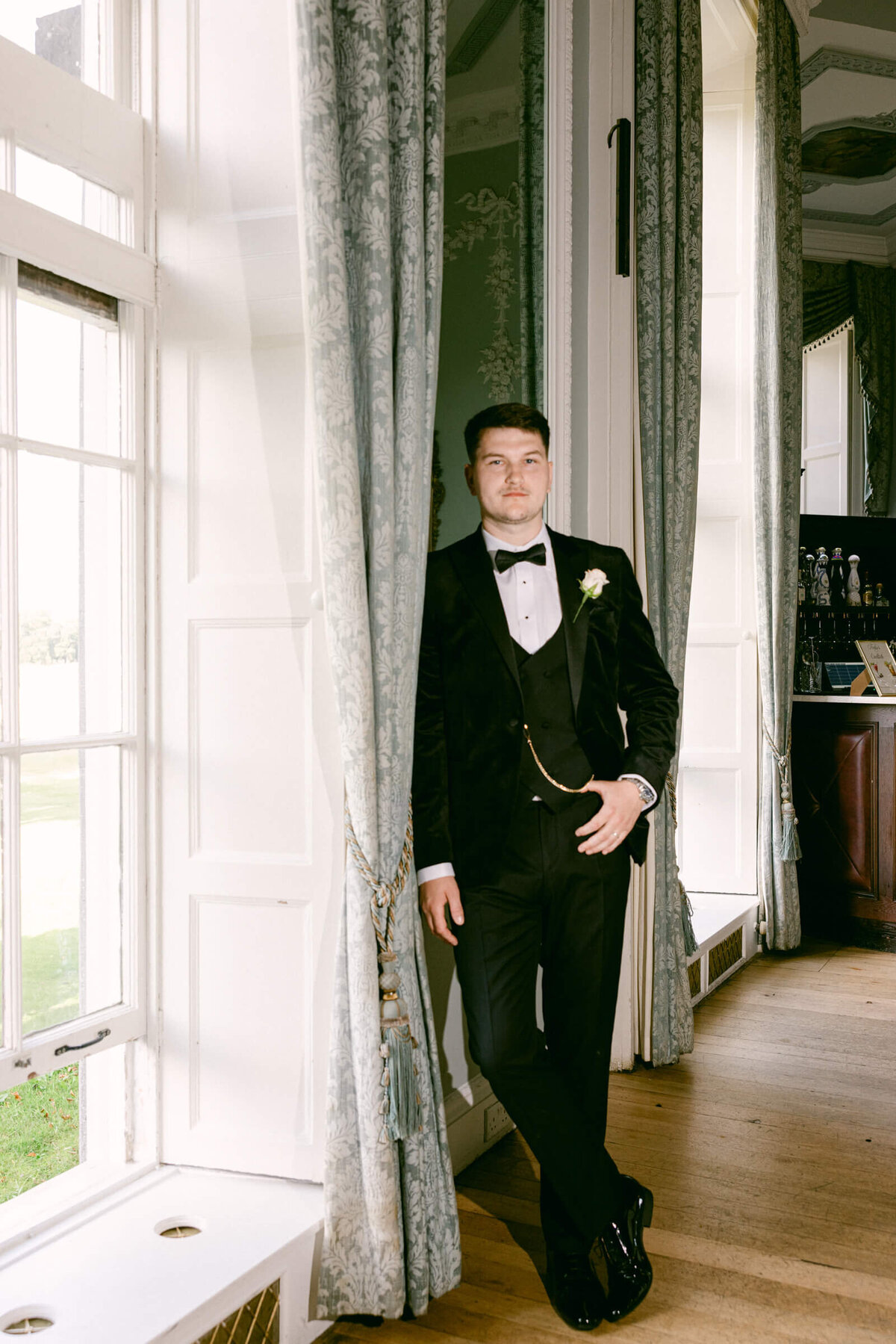 A wedding photo of a groom posing for a portrait at Luttrellstown Castle