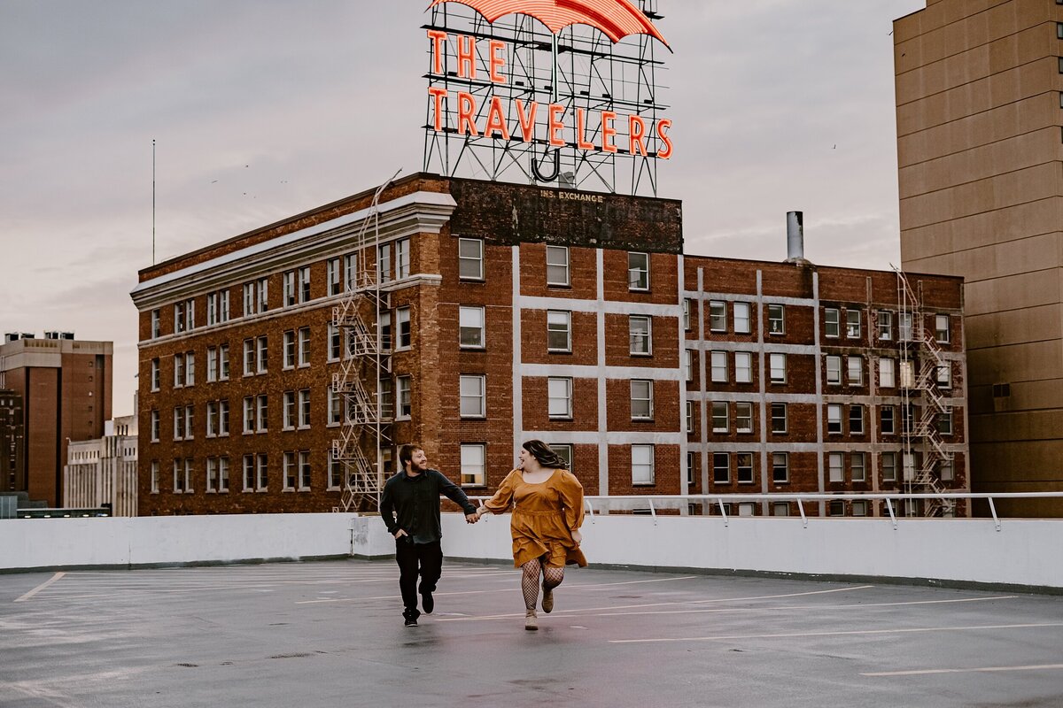 couple-running-rooftop-travelers-des-moines-storyteller-collective-photo-co