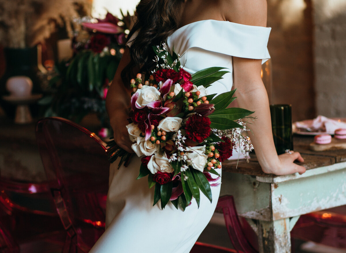 close up of bride holding her bouquet in downtown venue for elopement