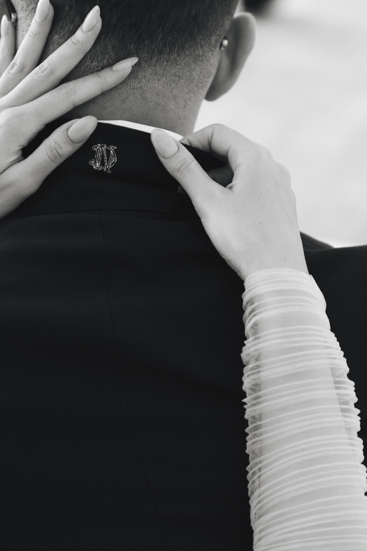 Traditional monogram embroidered under groom's wedding suit collar