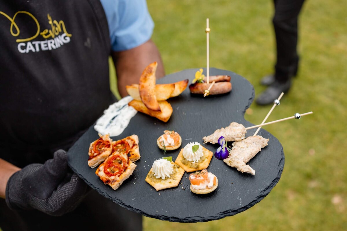 Canapés being served on a heart shaped slate platter