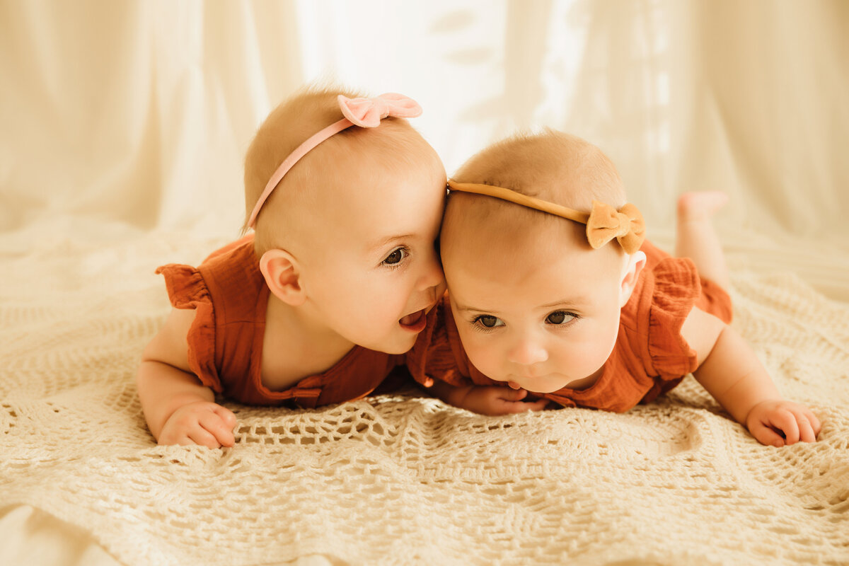 Twin milestone photo shoot little girls snuggling