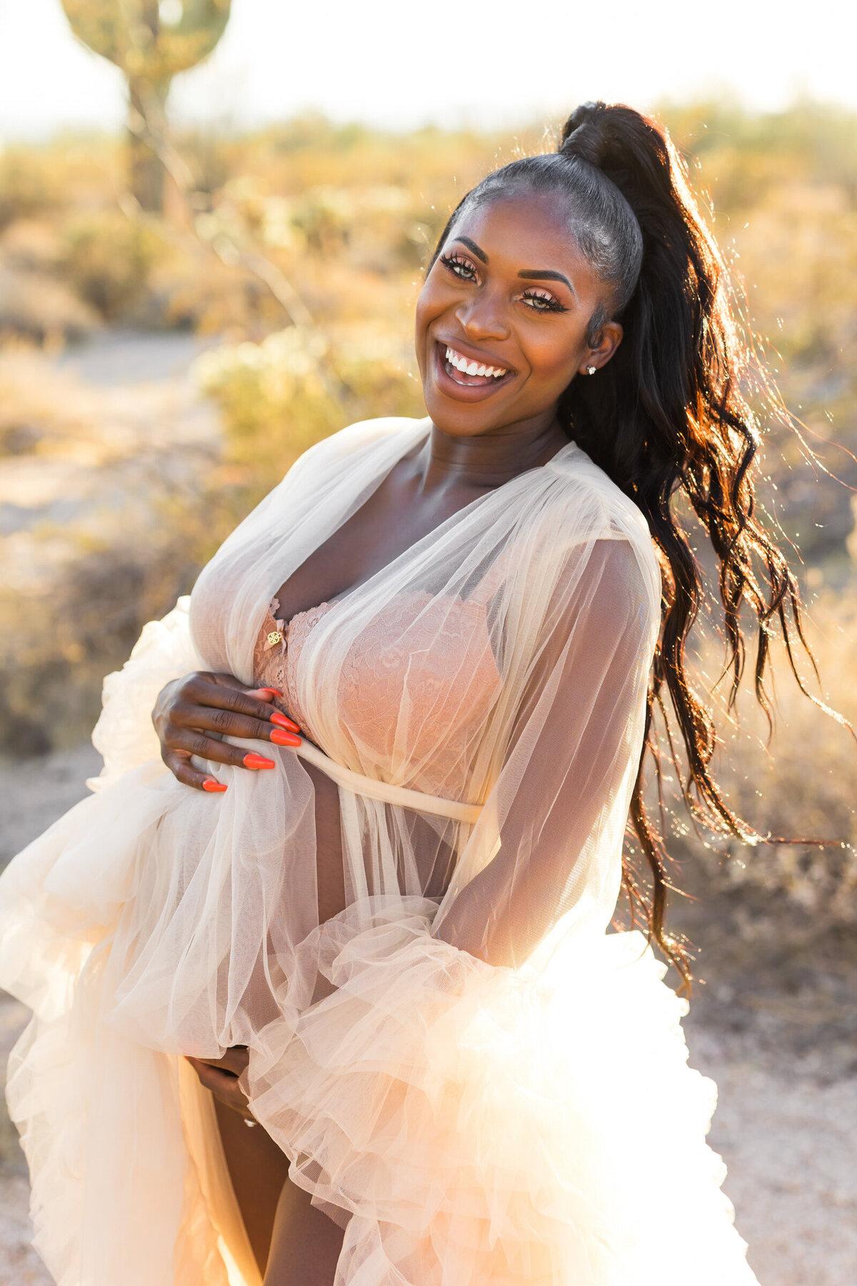 pregnant woman smiling for Scottsdale desert maternity photo session