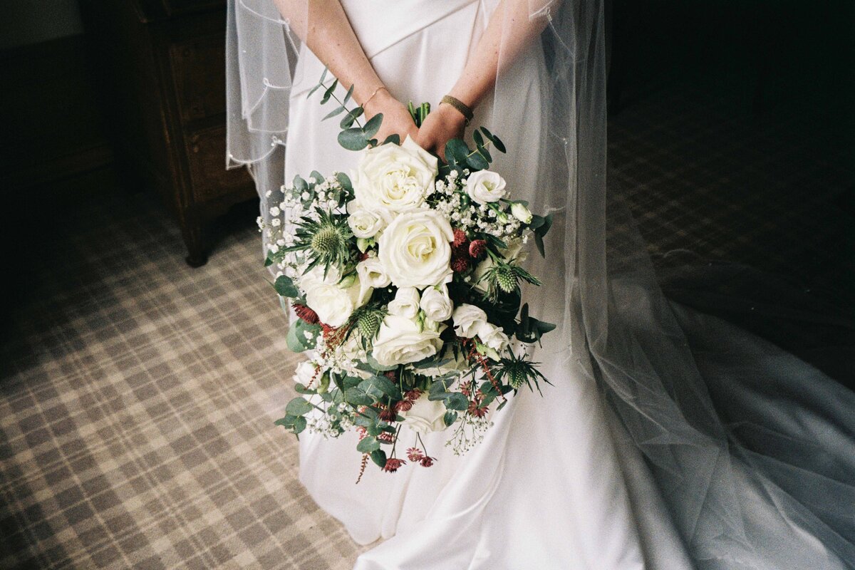 A bride hold her wedding bouquet.