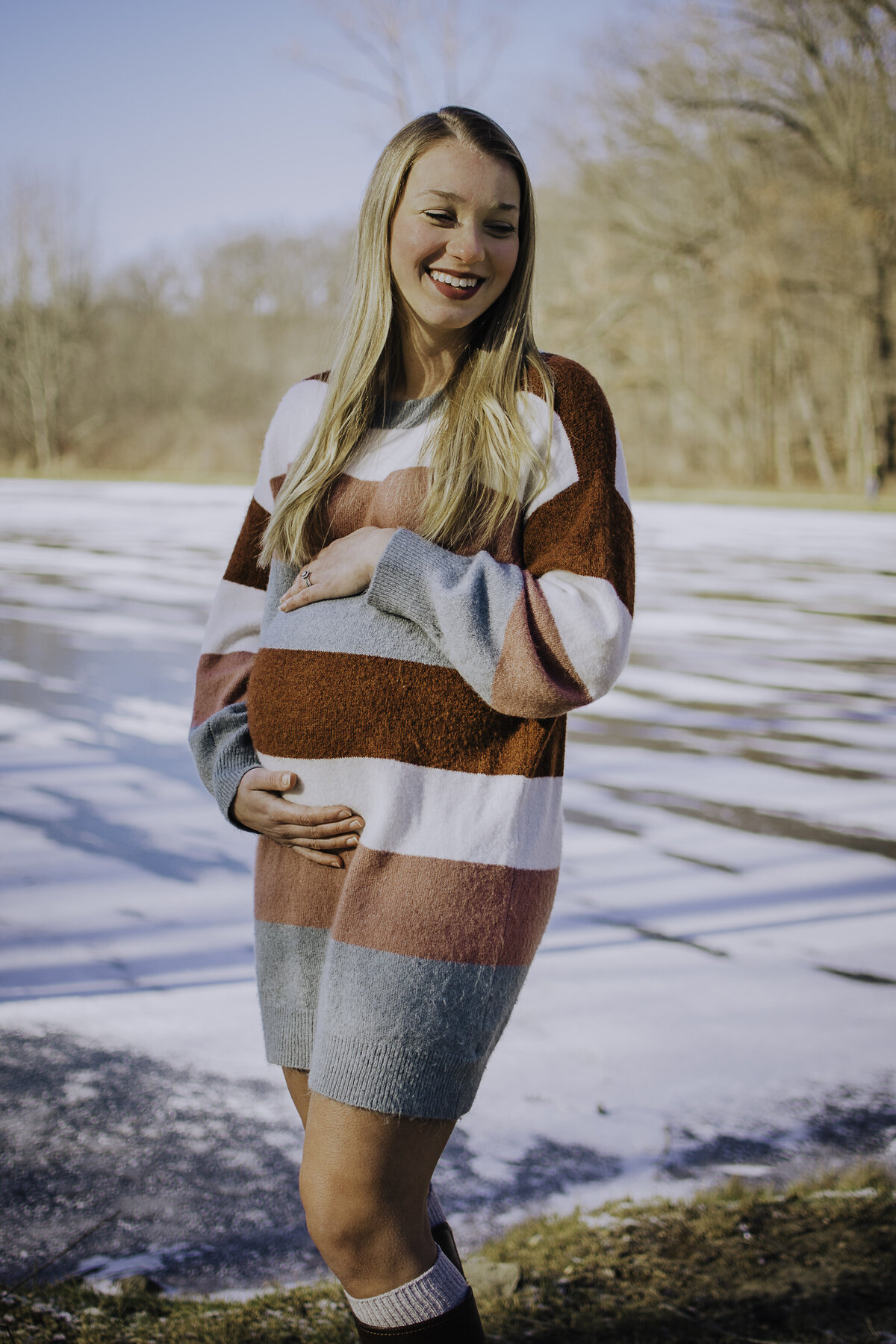 Verona B Photography captures a stunning maternity picture of a mom holding her belly at Turtle Pond in Akron, OH. The pond was frozen over and it was quite chilly but you could see the mom’s joy and anticipation for her unborn baby.