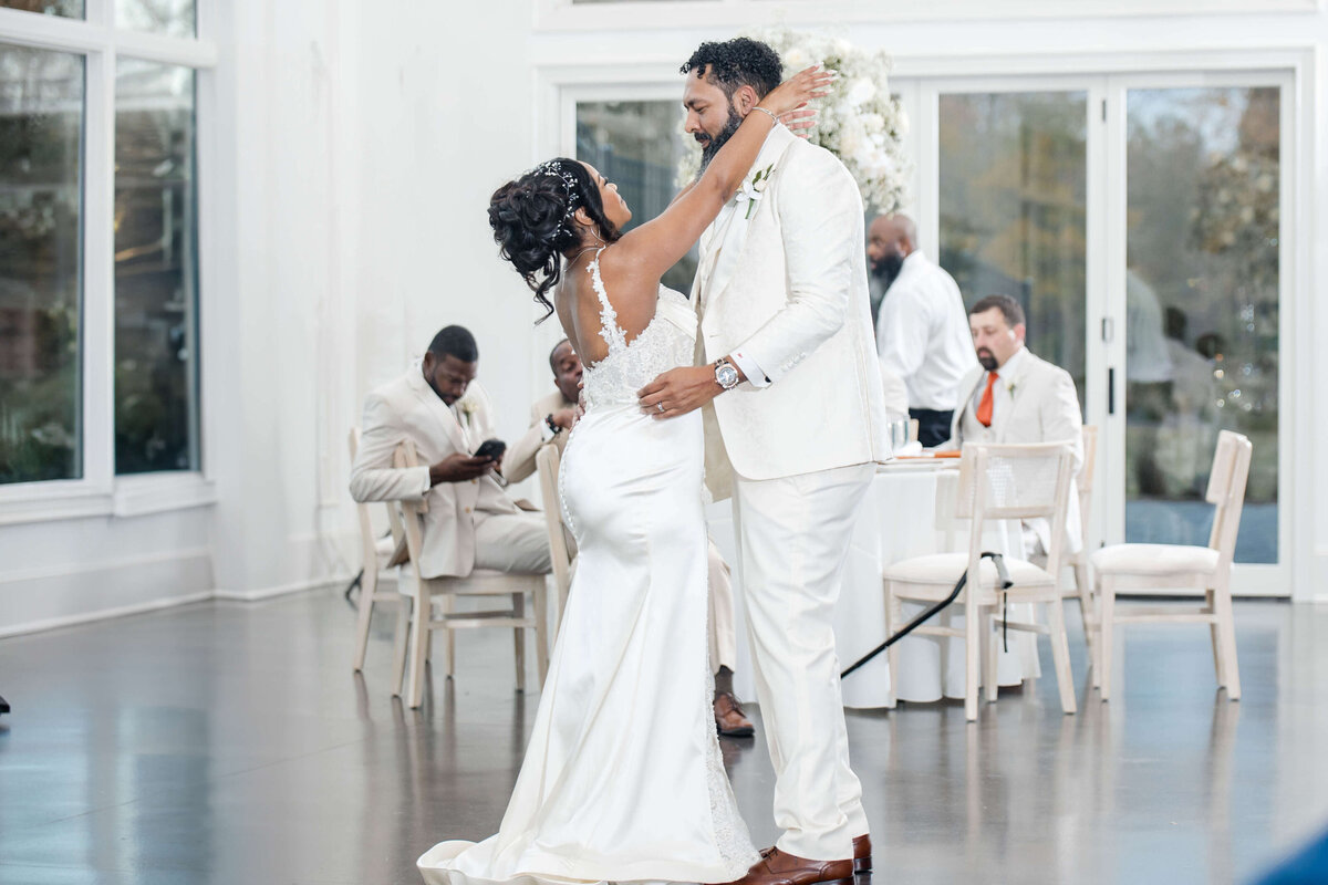 A deeply romantic moment as the couple shares a slow dance under soft lighting.