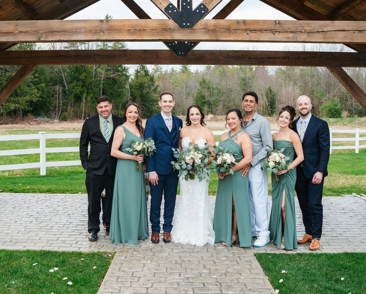 Elegant wedding flat lay with rings, florals, and invitations