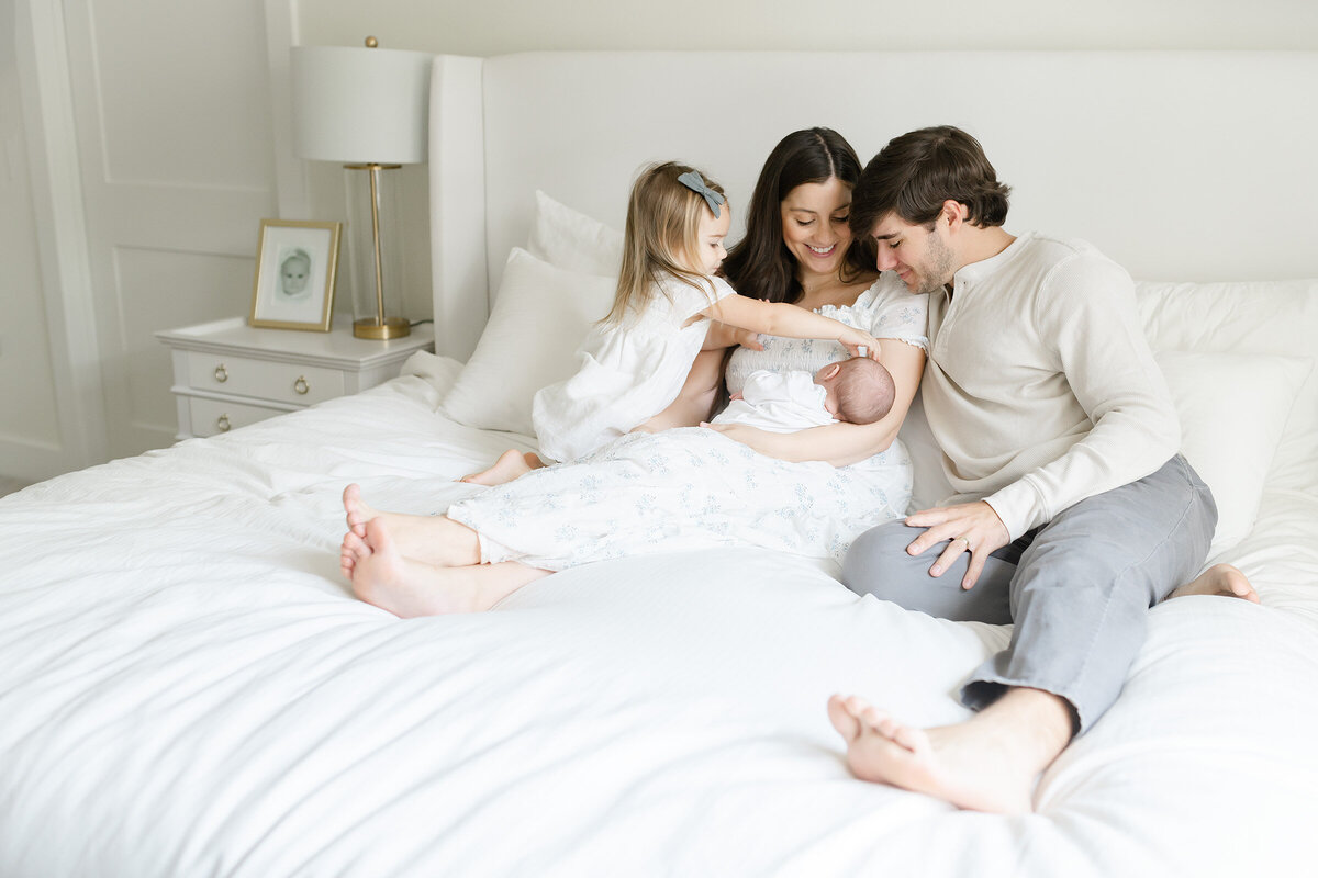 a family gathered on the bed