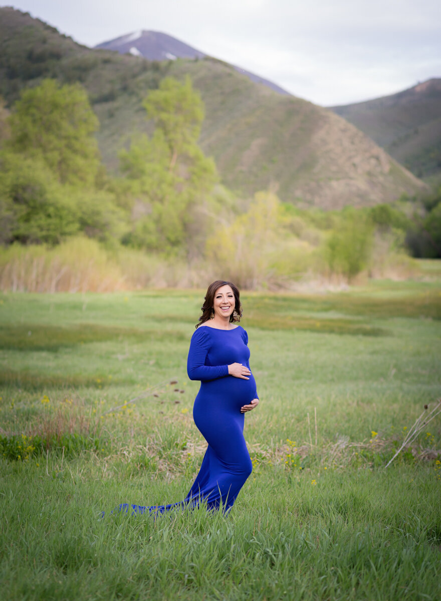 Smiling pregnant mom in Provo Canyon, Utah.