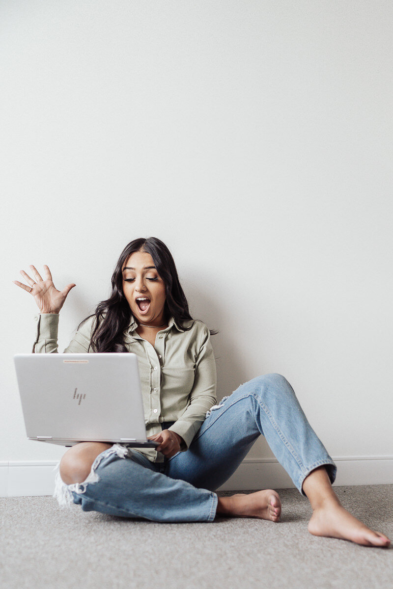 Entrepreneur looking at laptop and celebrating for fun portrait