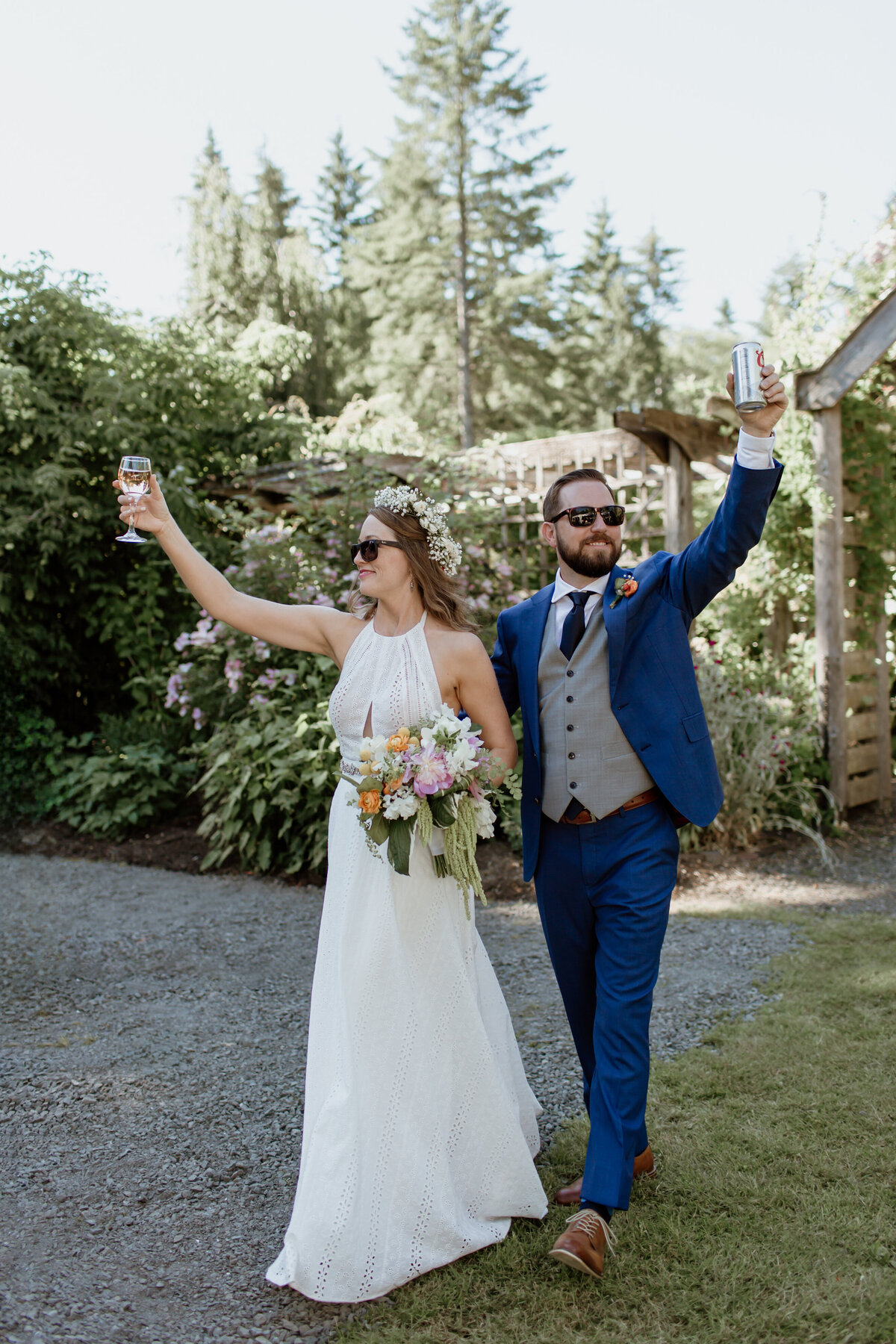 A fun moment as a bride and groom enter their outdoor wedding reception with drinks in hand. Captured by Fort Worth wedding photographer, Megan Christine Studio