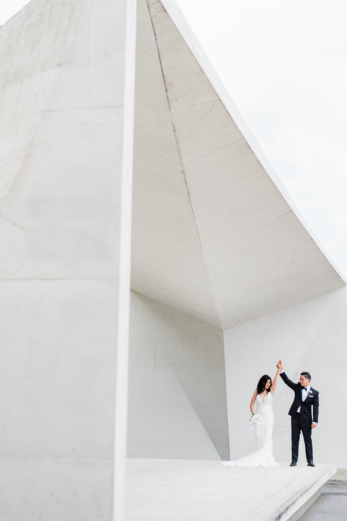 Elegant and modern couple dancing, twirling at the UBC Buchanan Courtyard in Kelowna, captured by Julie Jagt Photography, fine art wedding photographer in Vancouver, BC. Featured on the Bronte Bride Vendor Guide.