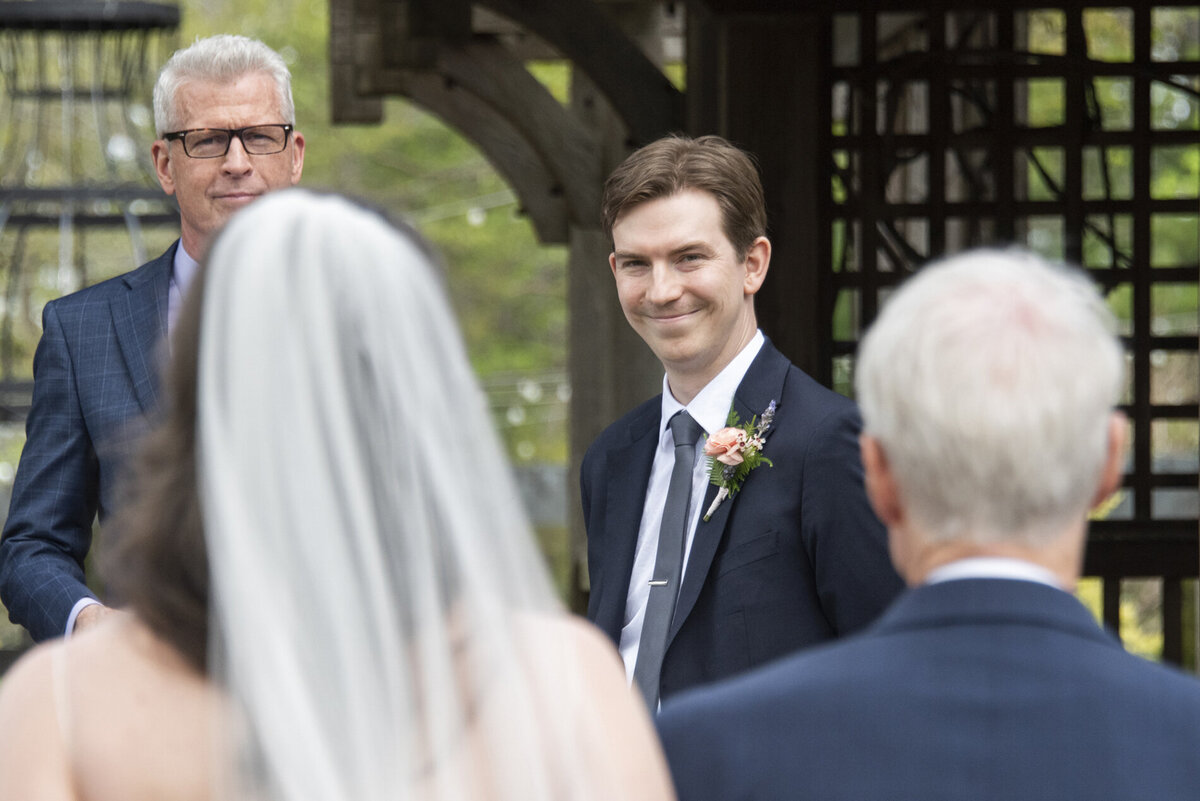 Groom sees bride at wedding ceremony