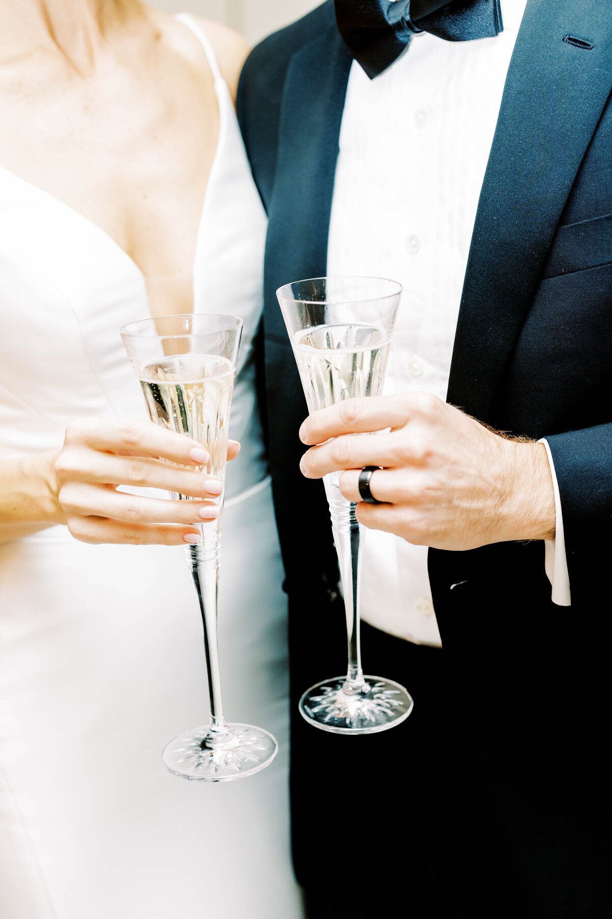 close up of bride and groom toasting with champagne