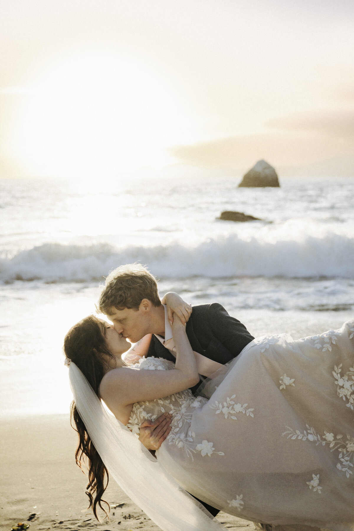 Bride and Groom at Marshall's Beach in San Francisco, California at sunset