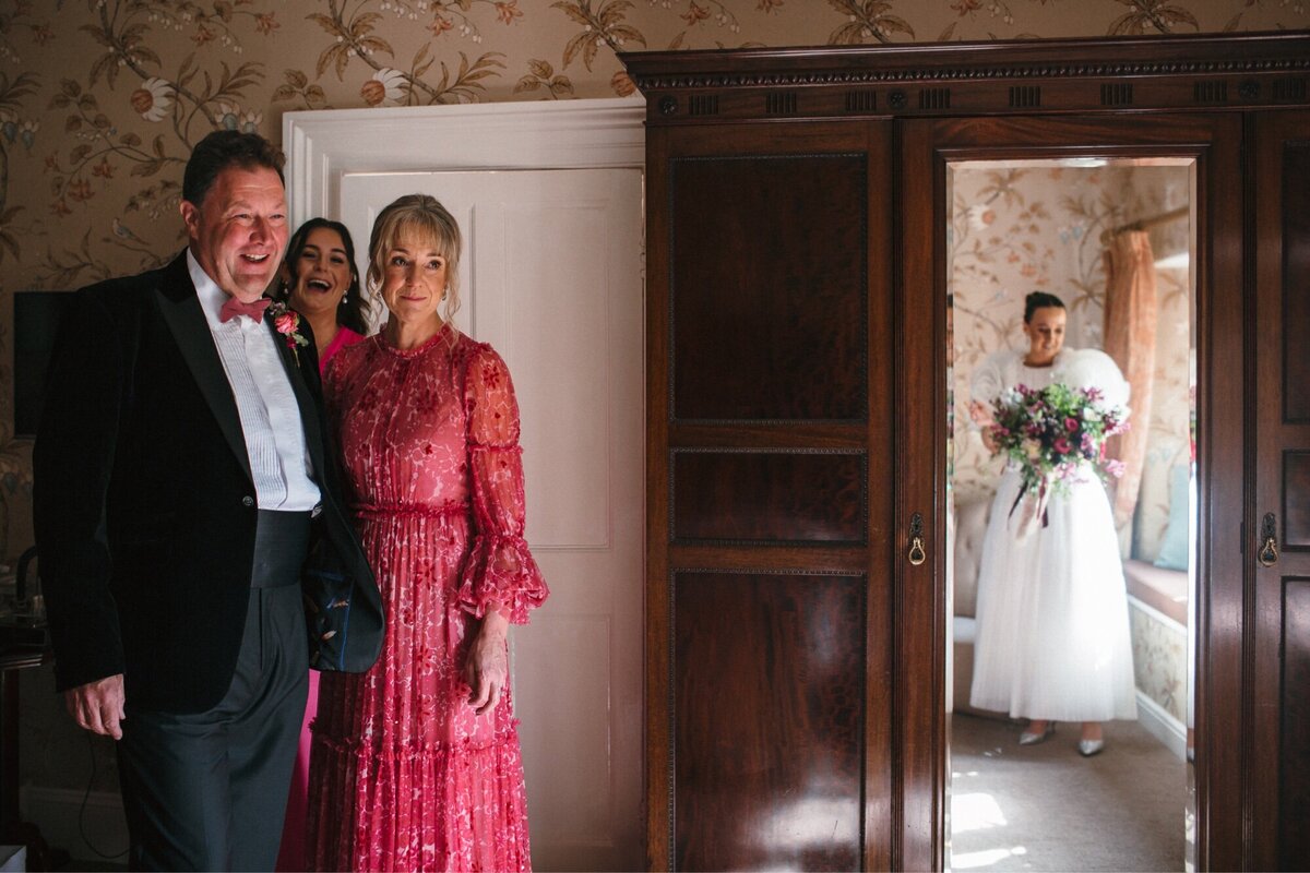 Parents emotional first look with bride 