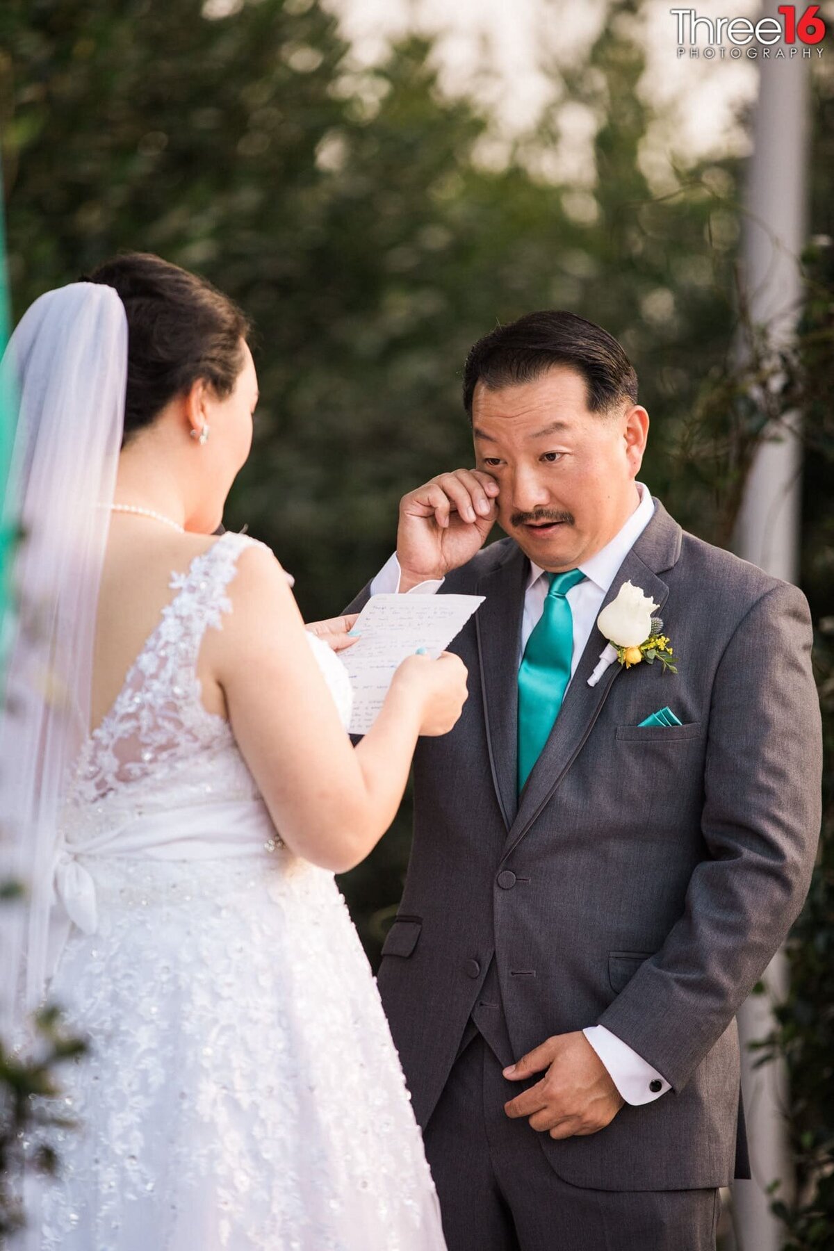 Groom sheds a tear as his Bride reads her vows to him