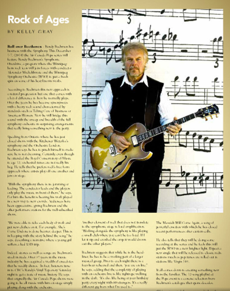 Randy Bachman Style Manitoba Magazine article standing against wall with musical notes painted on it holding guitar