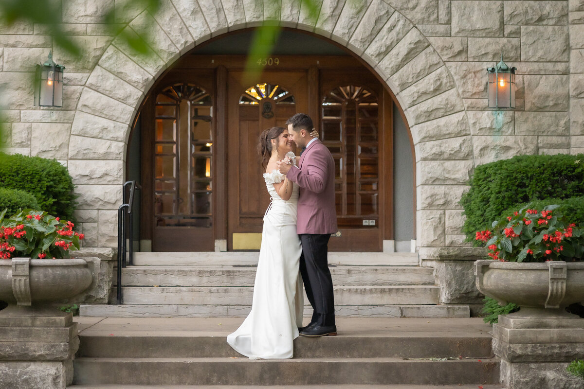 Bride and Groom kissing in front of castle