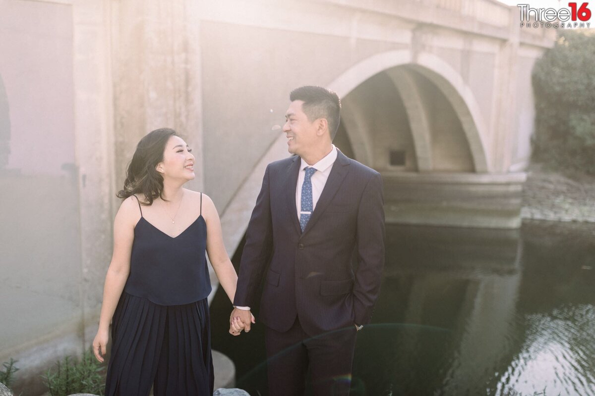 Engaged couple gaze at each other during photo shoot