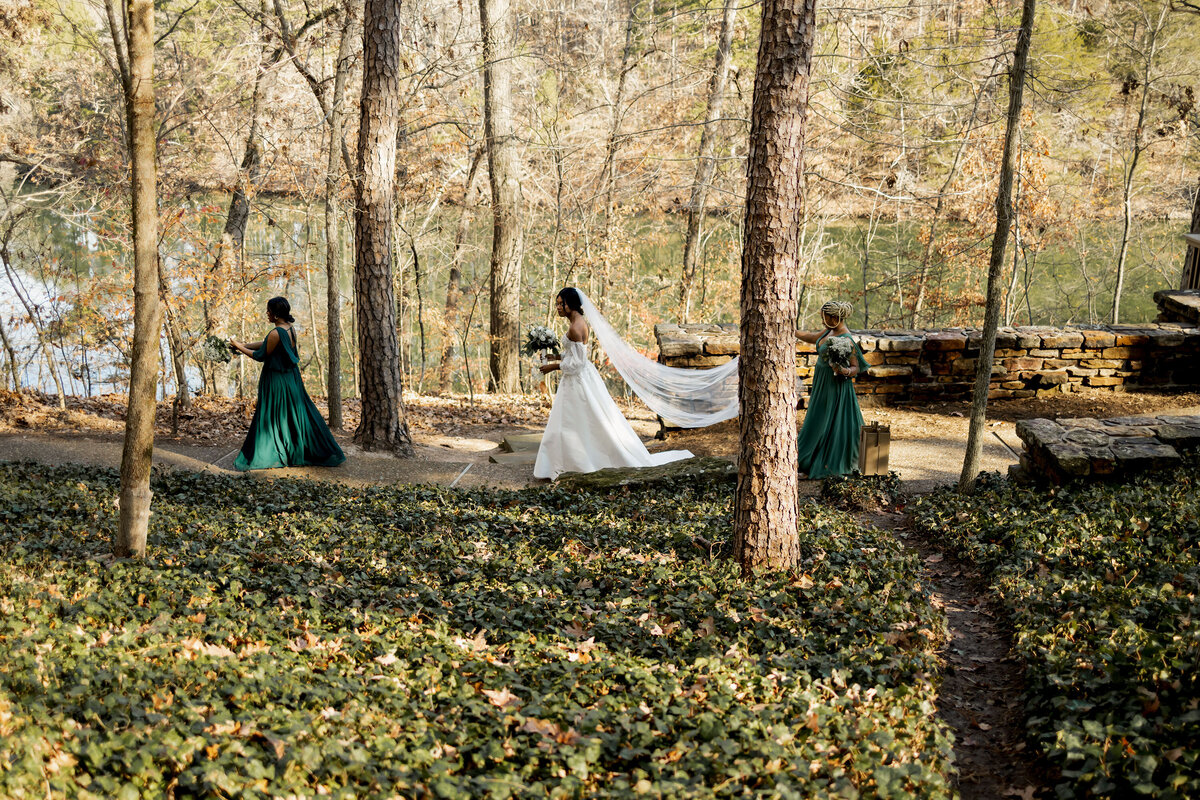 a bride and her attendants walk on the path at cooper memorial chapel