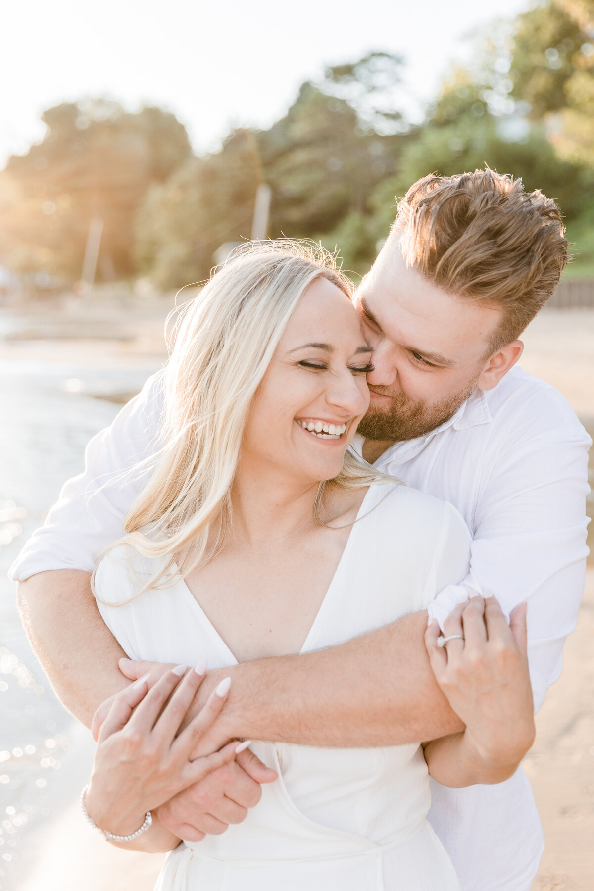 Couple smiling and kissing on a beach