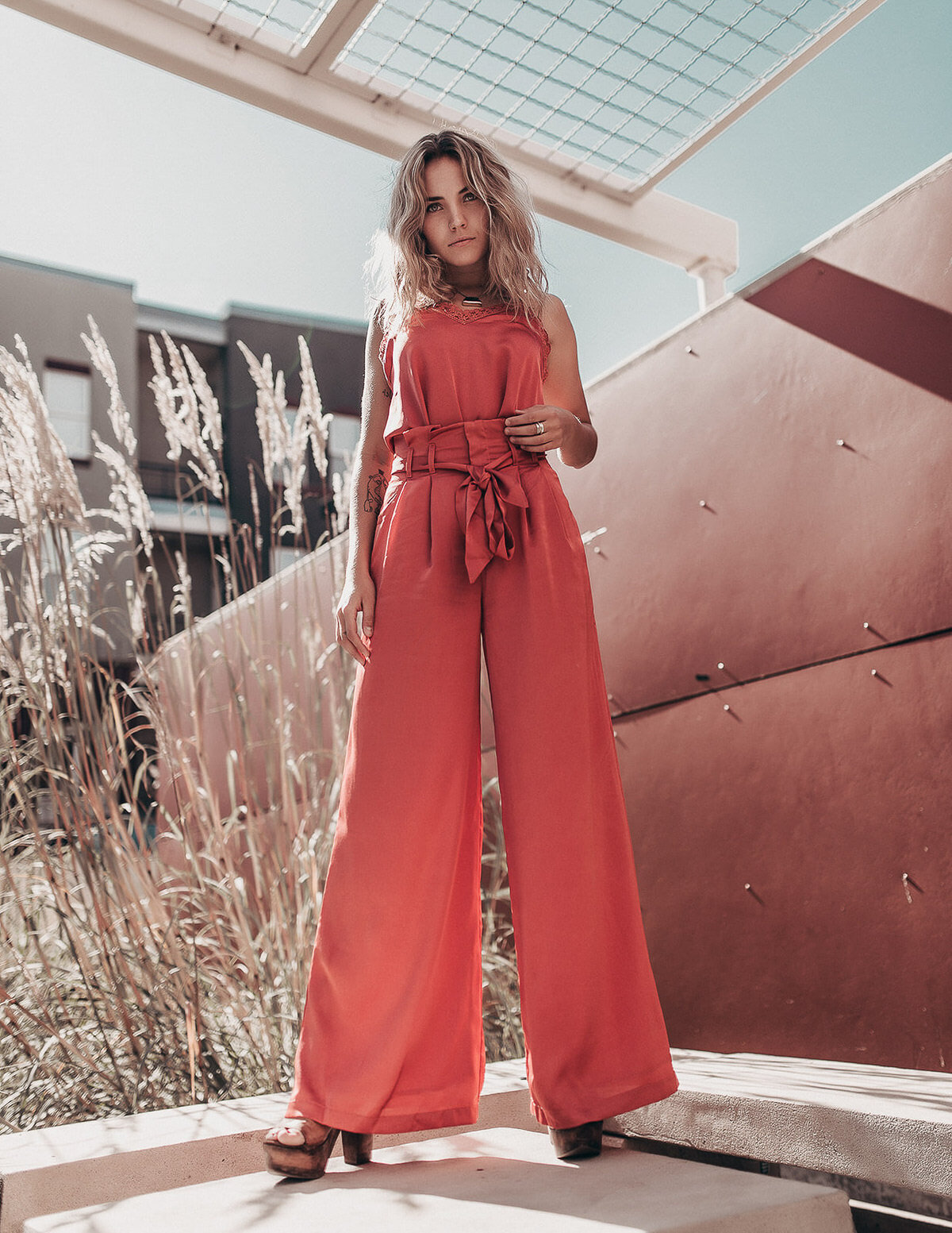 fashion blogger standing tall in pink outfit