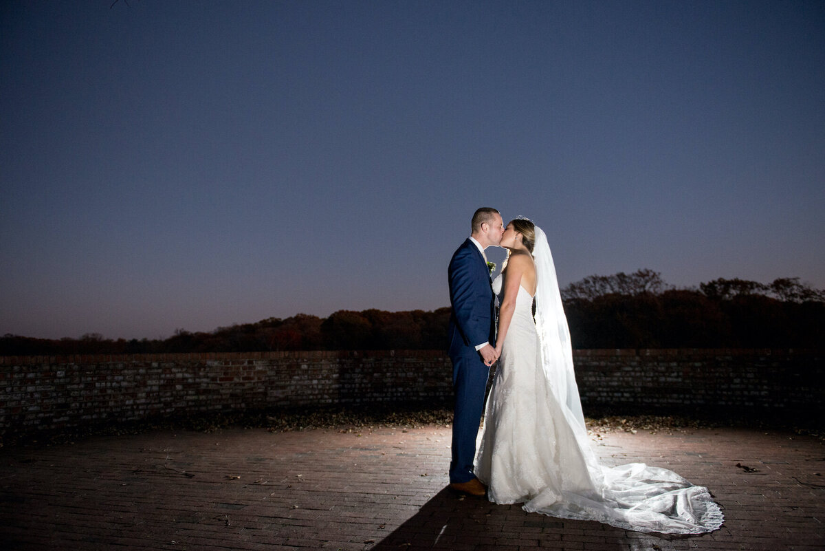 bride and groom holding each other at night at Heritage Club at Bethpage