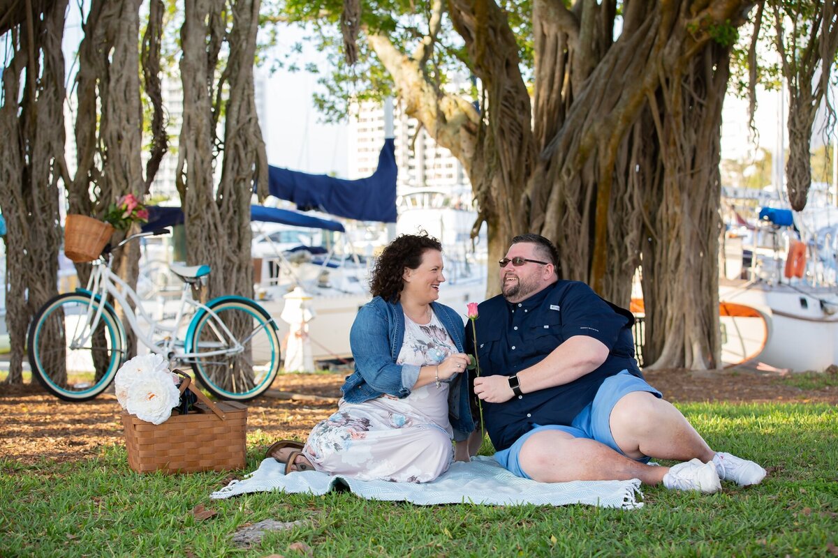 Engaged couple having a picnic by the banyan tree at Bayfront Park downtown Sarasota, Fl.