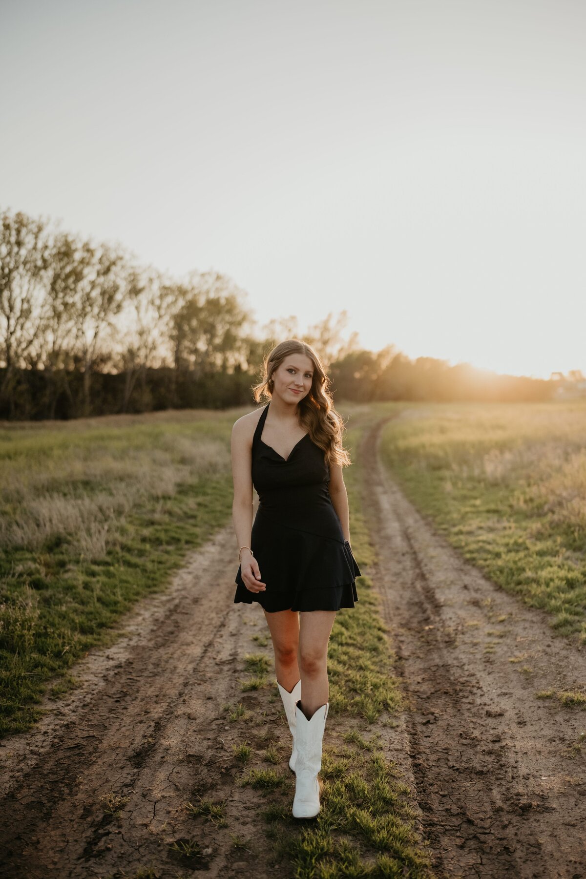 senior walking in field at sunset, senior photography session in amarillo Texas, , Emily wheeler photography