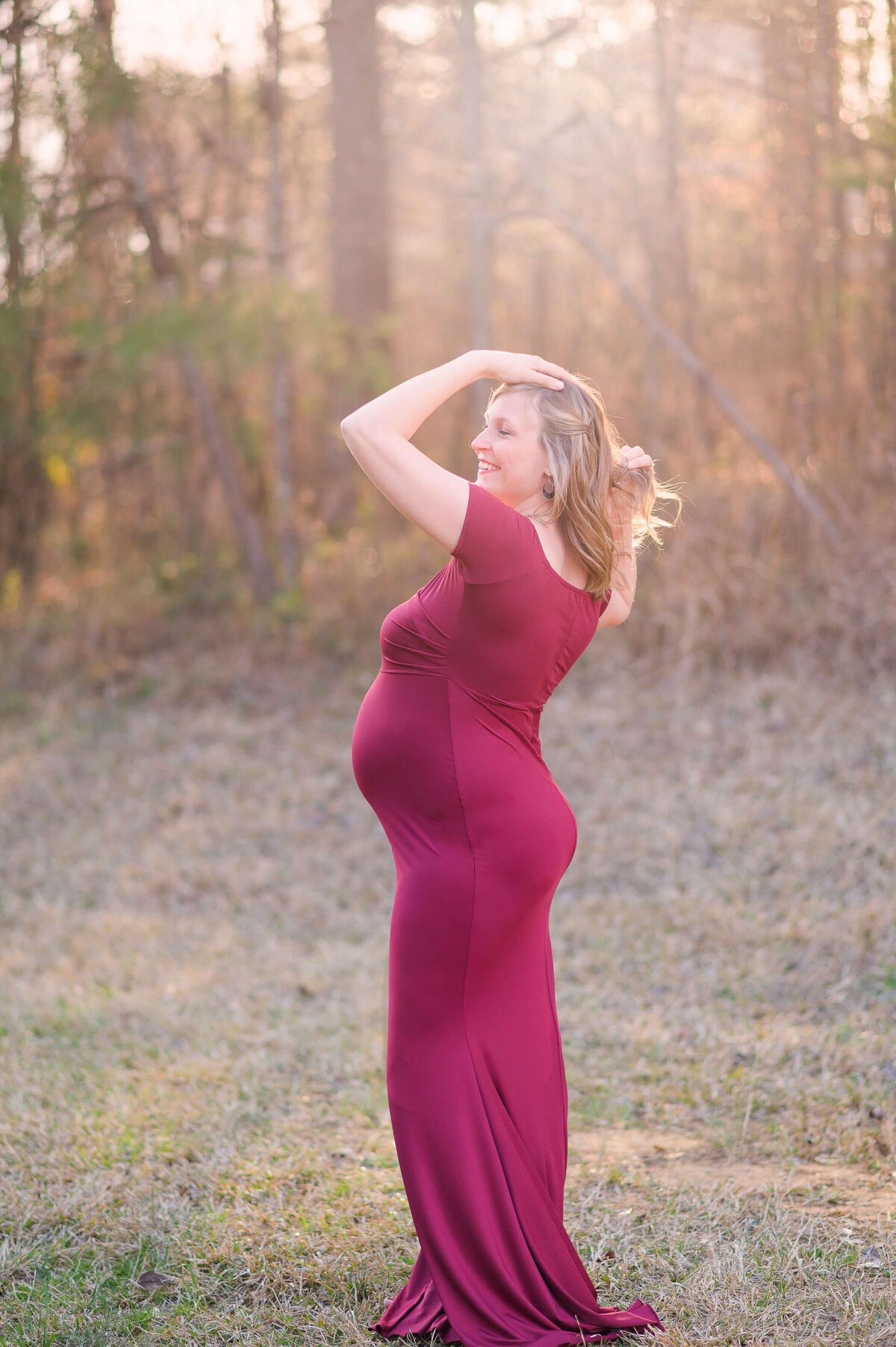 mom to be wearing a red maternity dress by elizabeth klusmann photography