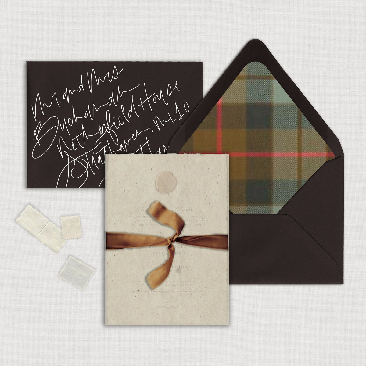Letterpress Scotland Destination Wedding invitation suite with copper wax seal on textured thick handmade paper with chocolate brown mailing envelope with plaid tartan envelope liner wrapped with a textured paper wrap and tied with copper velvet ribbon.