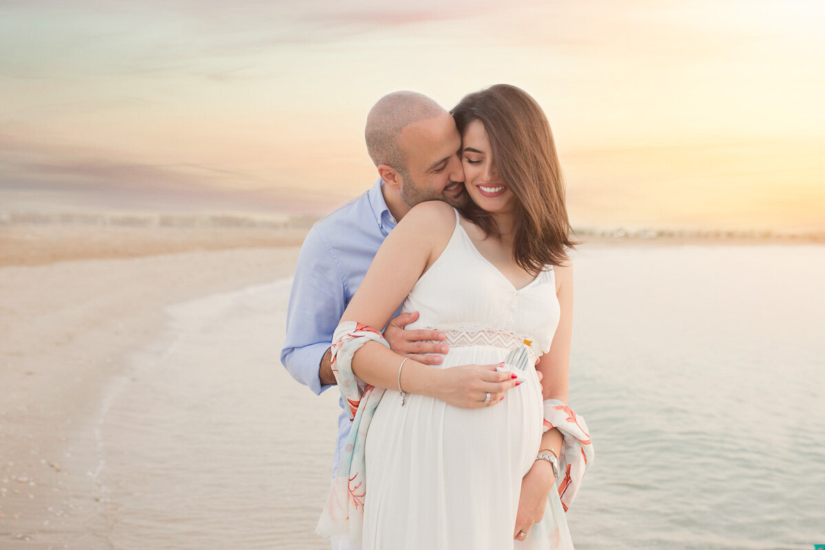 Romantic beach photo of a couple cuddling in Victoria British Columbia by Yuliia Terziian Photography