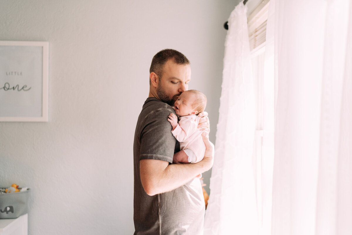 father embraces infant baby girl oklahoma