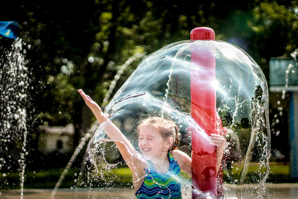 girl playin in splash pad Iowa City