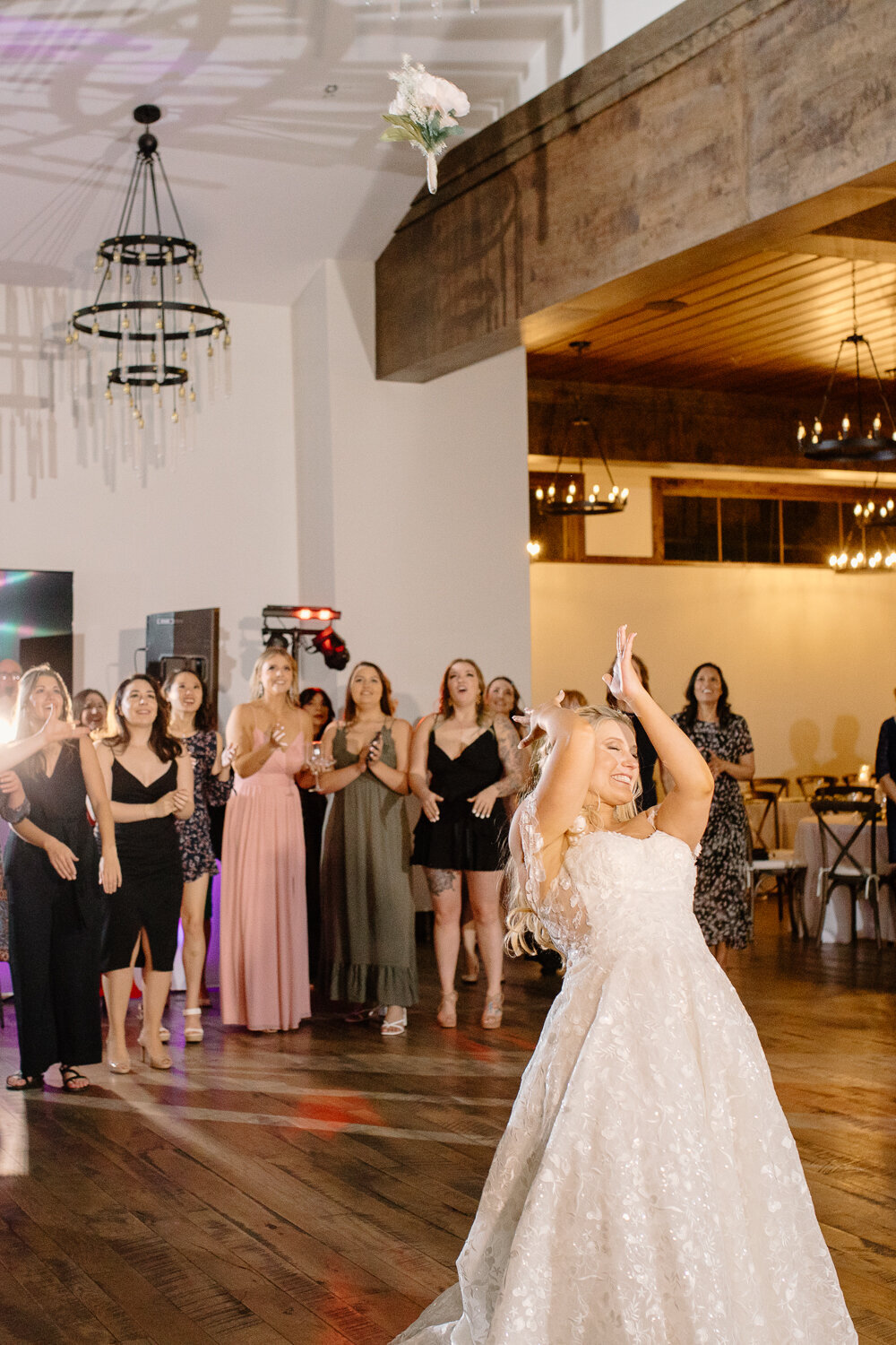 A bride throws her bouquet during her wedding reception in Estes Park, Colorado.