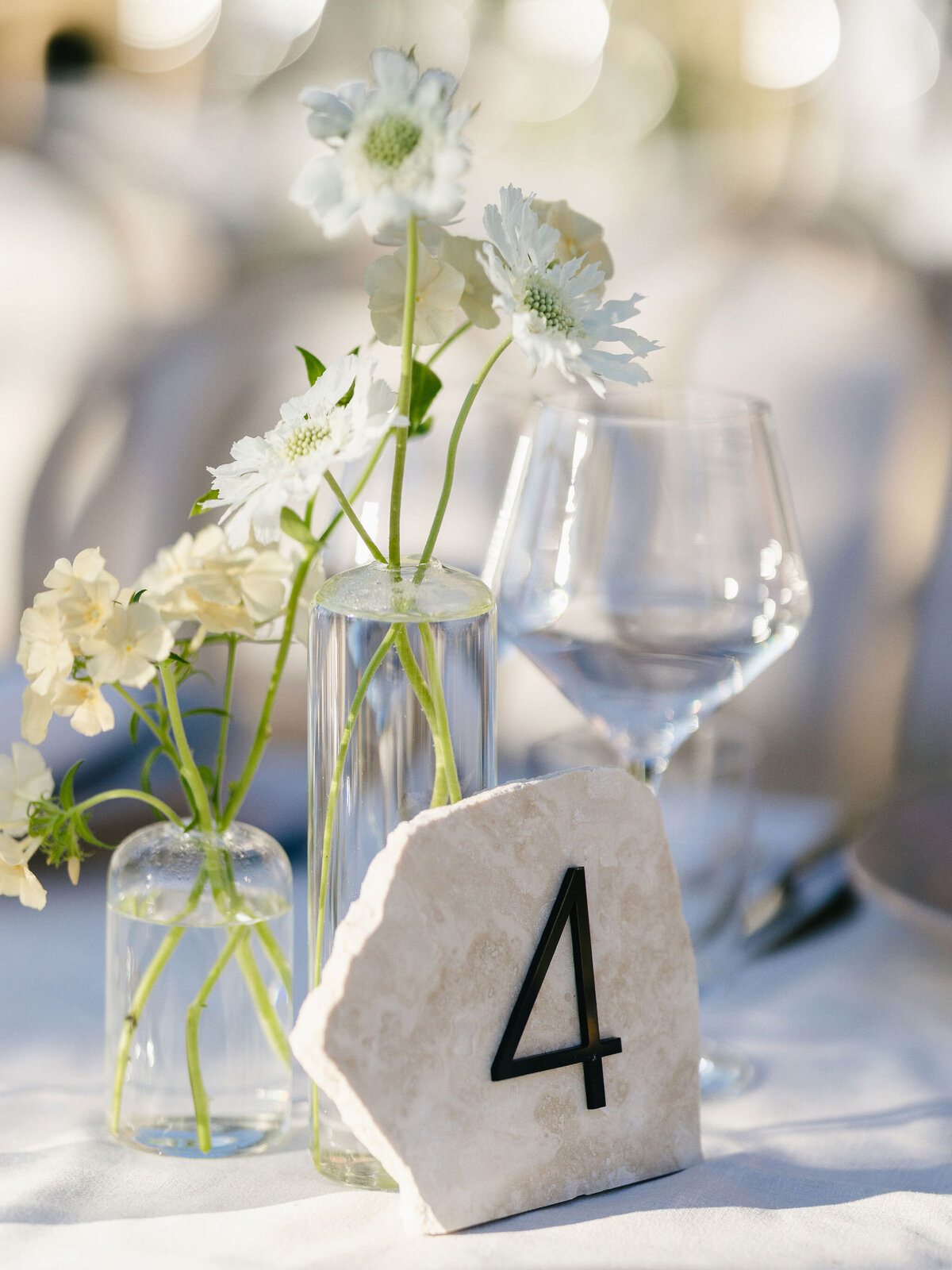 unique, moder and bold table number using travertine stone and matte black table number
