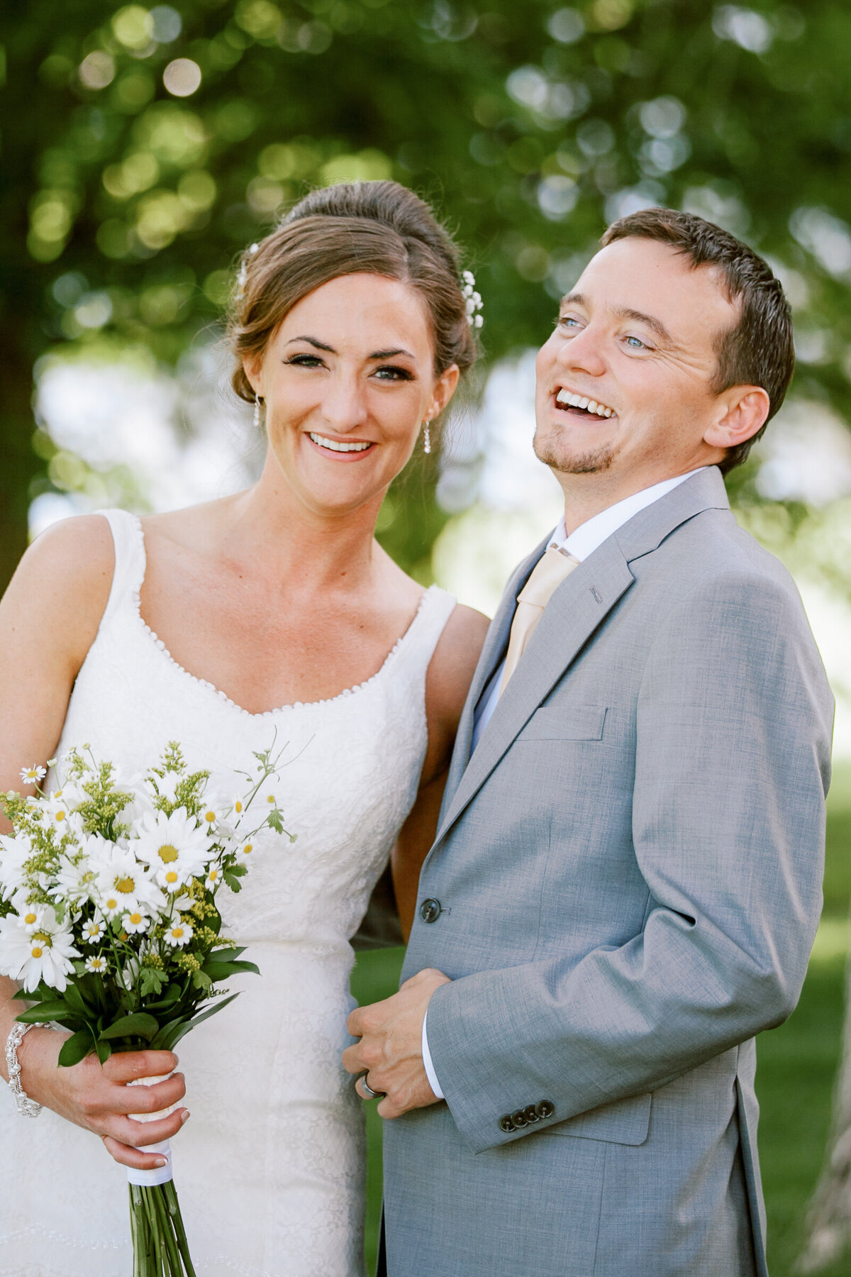 Colorado wedding couple pose for portraits during their Barn at Raccoon Creek wedding