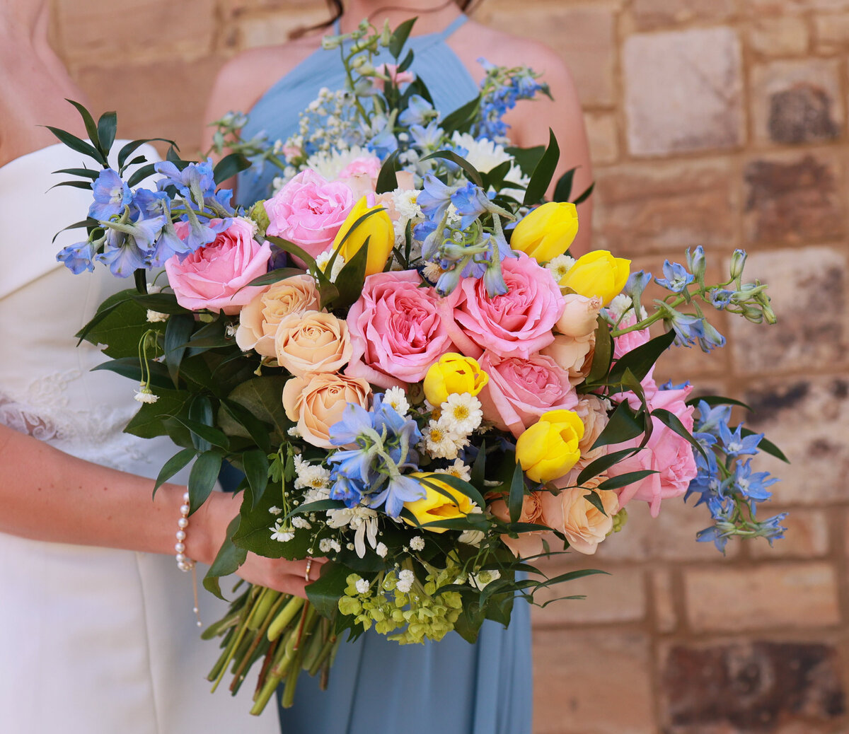 bridal bouquet with yellow pink and peach roses