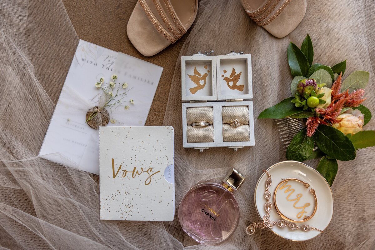 Bridal details, including rings, shoes, vow book, perfume. Photo by wedding photographer in Sacramento Philippe Studio Pro.