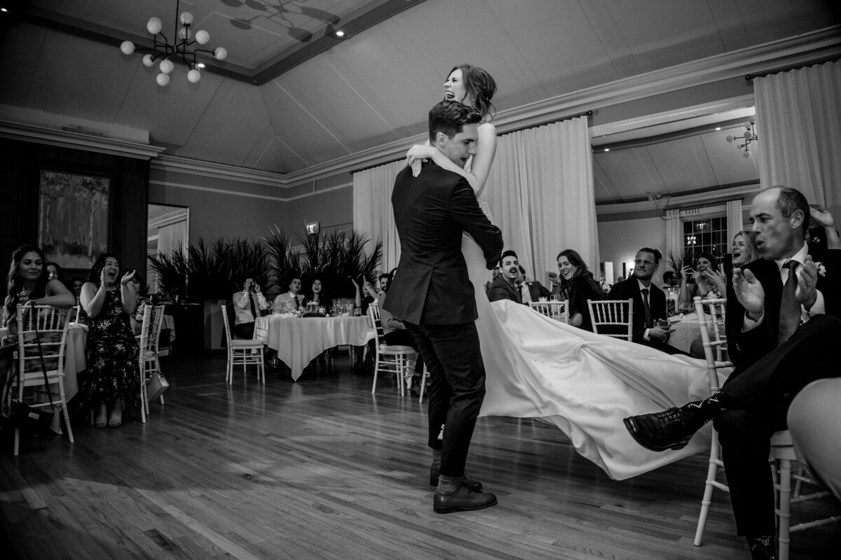 Groom lifts up his bride during their first dance