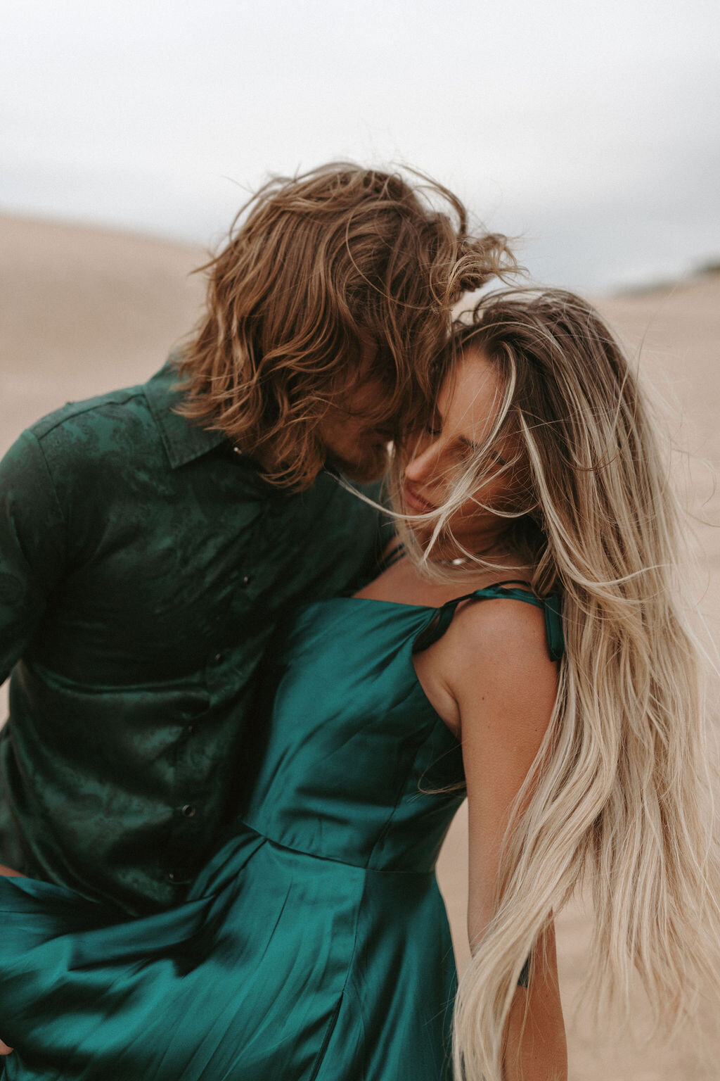 Couple embracing during their session in the Michigan sand dunes