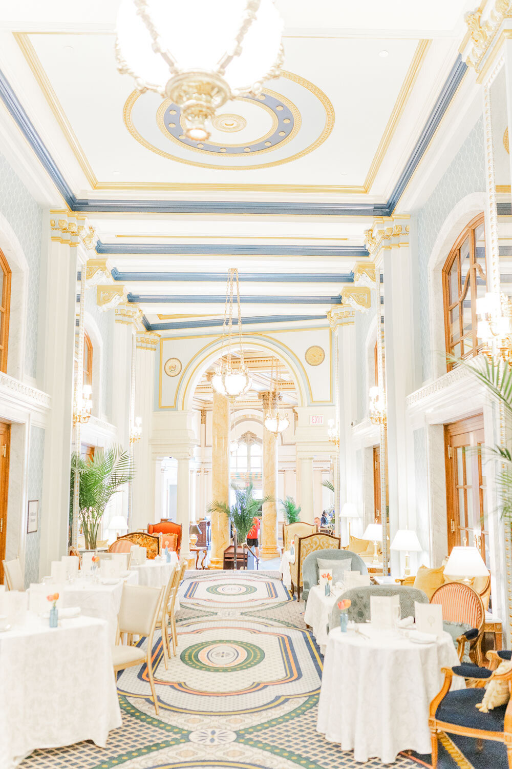 Luxurious hotel dining hall with chandeliers and seating